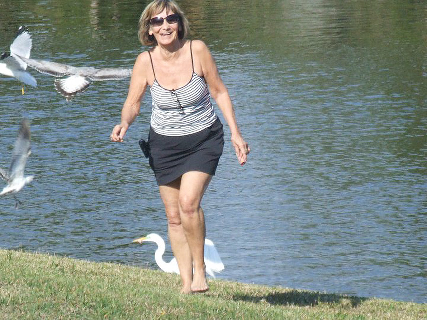 My happy mom barefoot by the lake with the birds